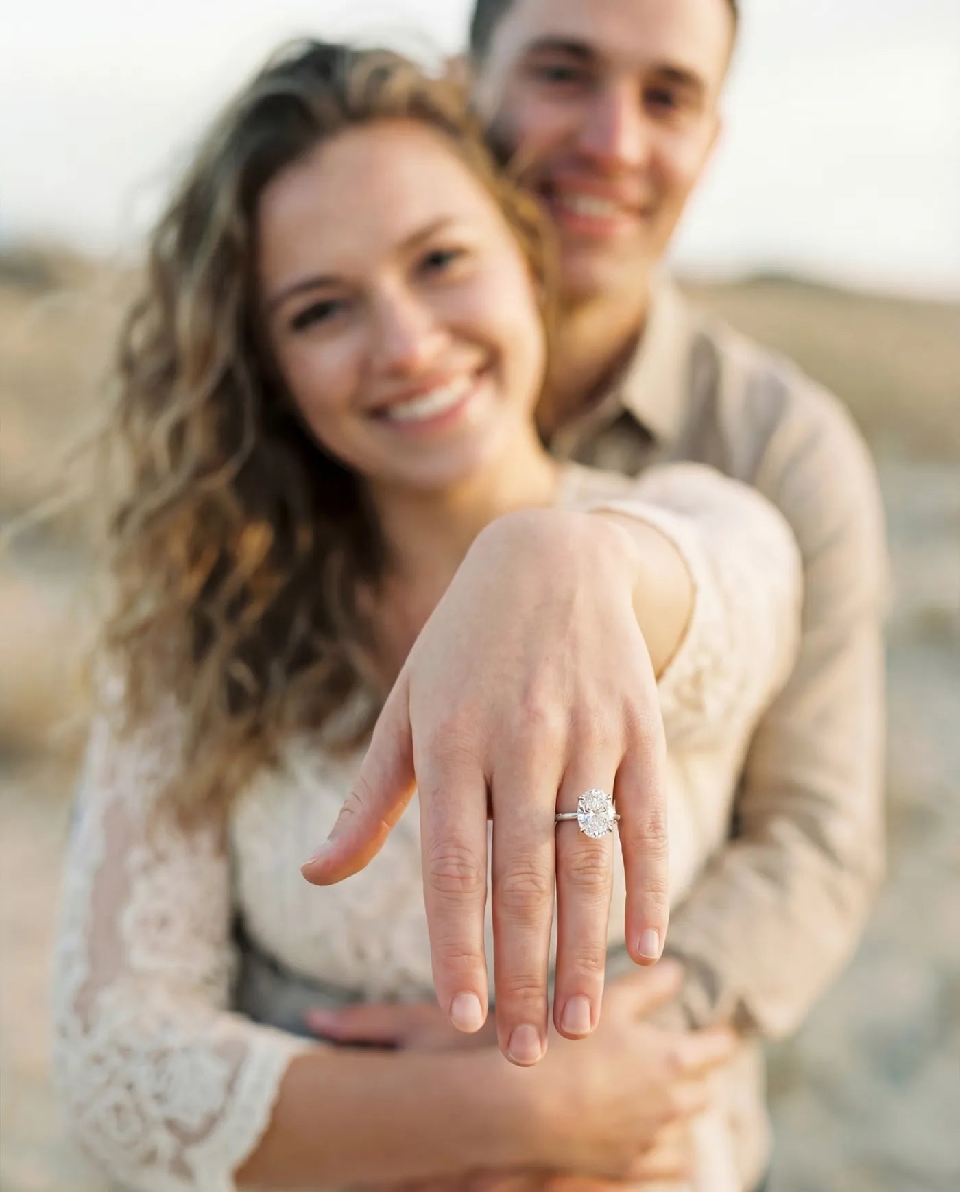 Couple showing an oval solitaire engagement ring